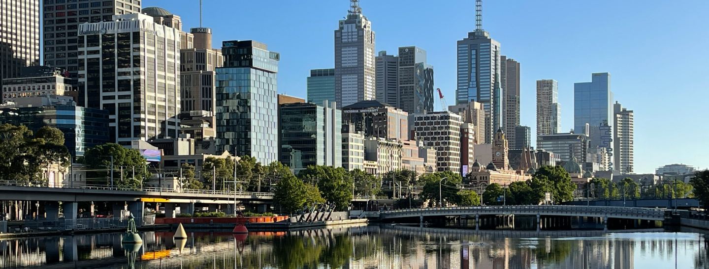 Landscape shot on Melbourne CBD with office buildings, a river and bridge in view