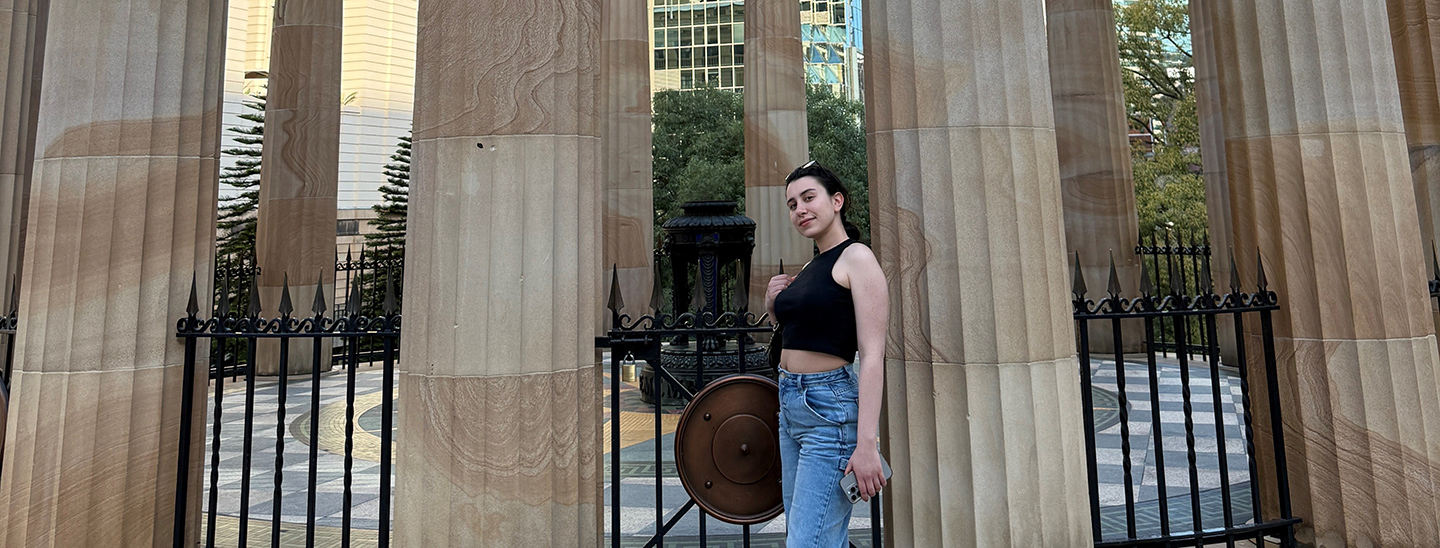Charles Sturt University Sydney Melbourne Student Sena standing in front of a monument with pillars