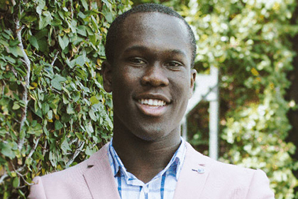 Profile photo of Yaw Kyei in a pink suit jacket and checkered shirt