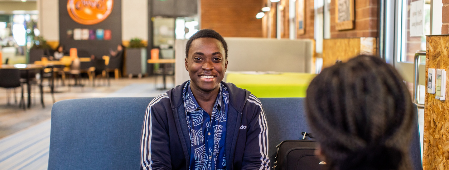 Male student happy sitting