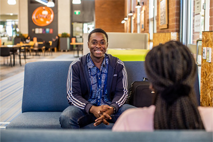 Male student happy sitting