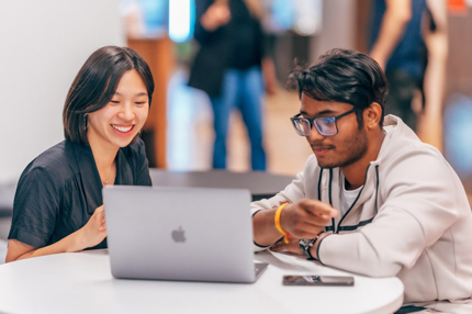 Student and teacher with laptop