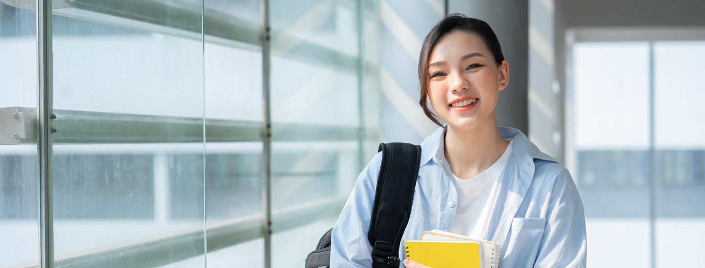 Student inside smiling