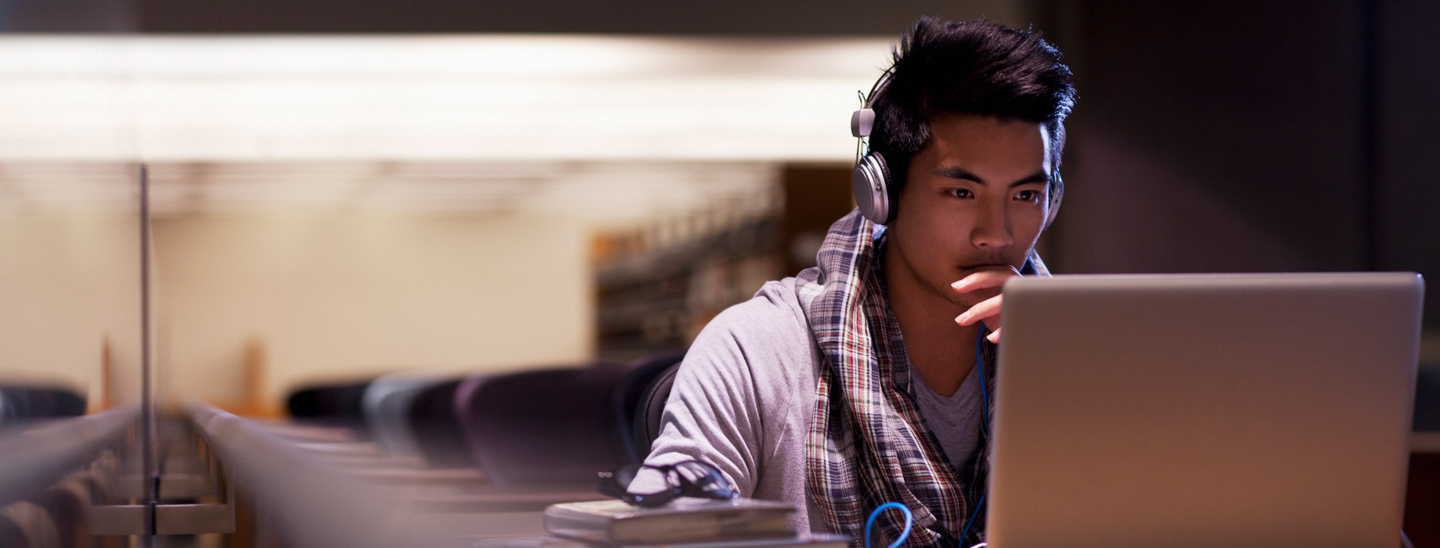 Student wearing headphones laptop