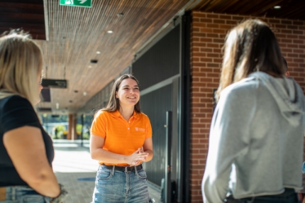 Students outside on campus talking