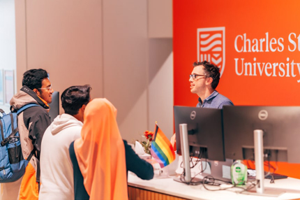 Students standing reception desk