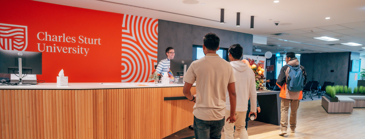 Students walking towards reception desk