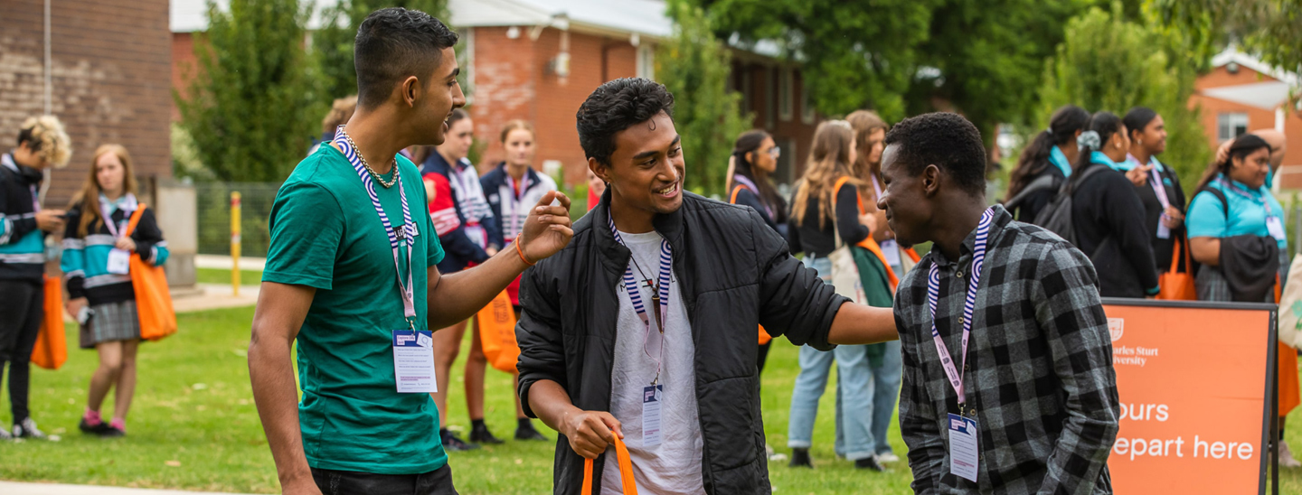 Three students standing at explore day