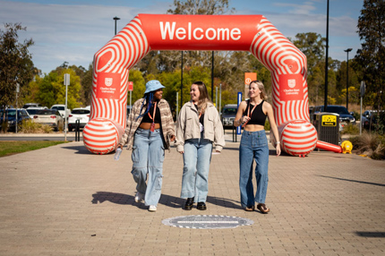 Three students walking open day